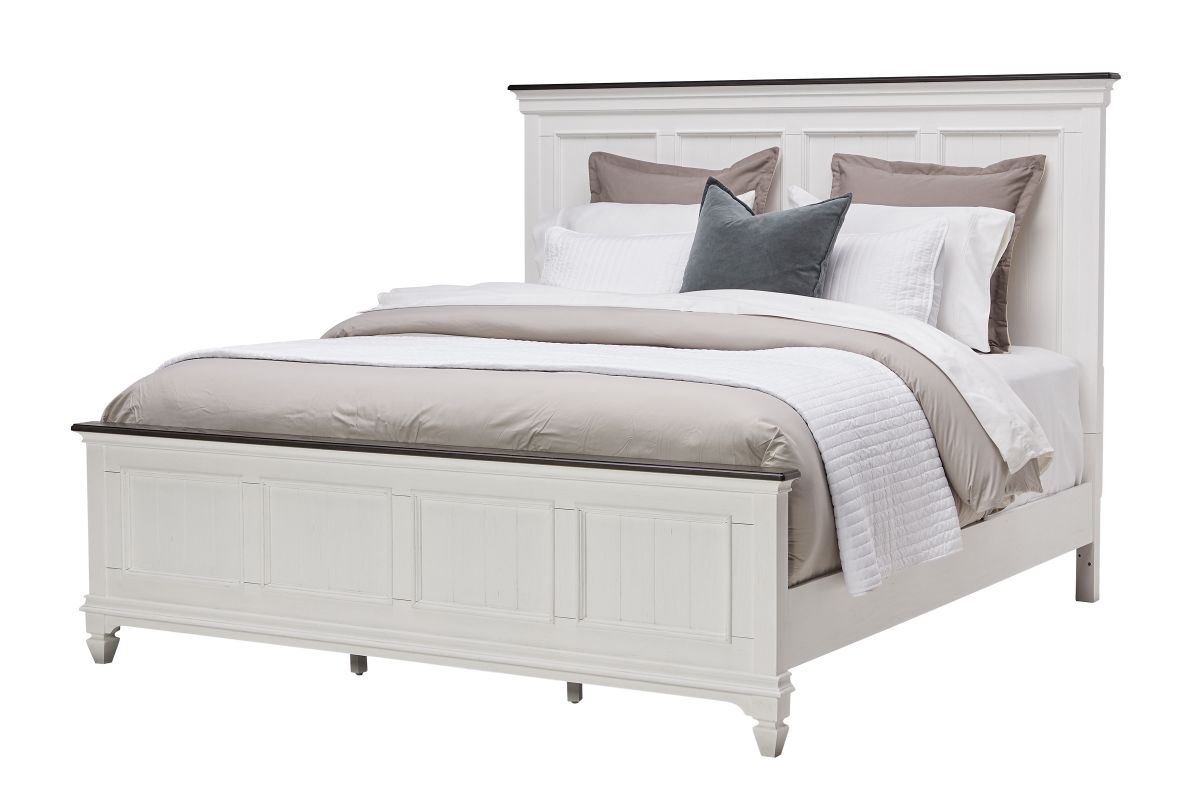 Corner view of a white wood king size bed with a mattress and gray pillows