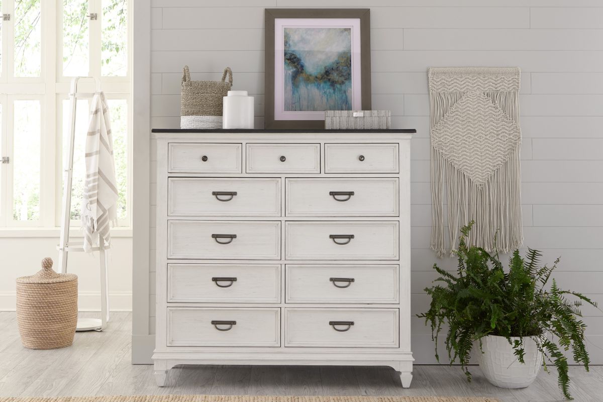11-drawer chesser made from white wood in a bedroom.