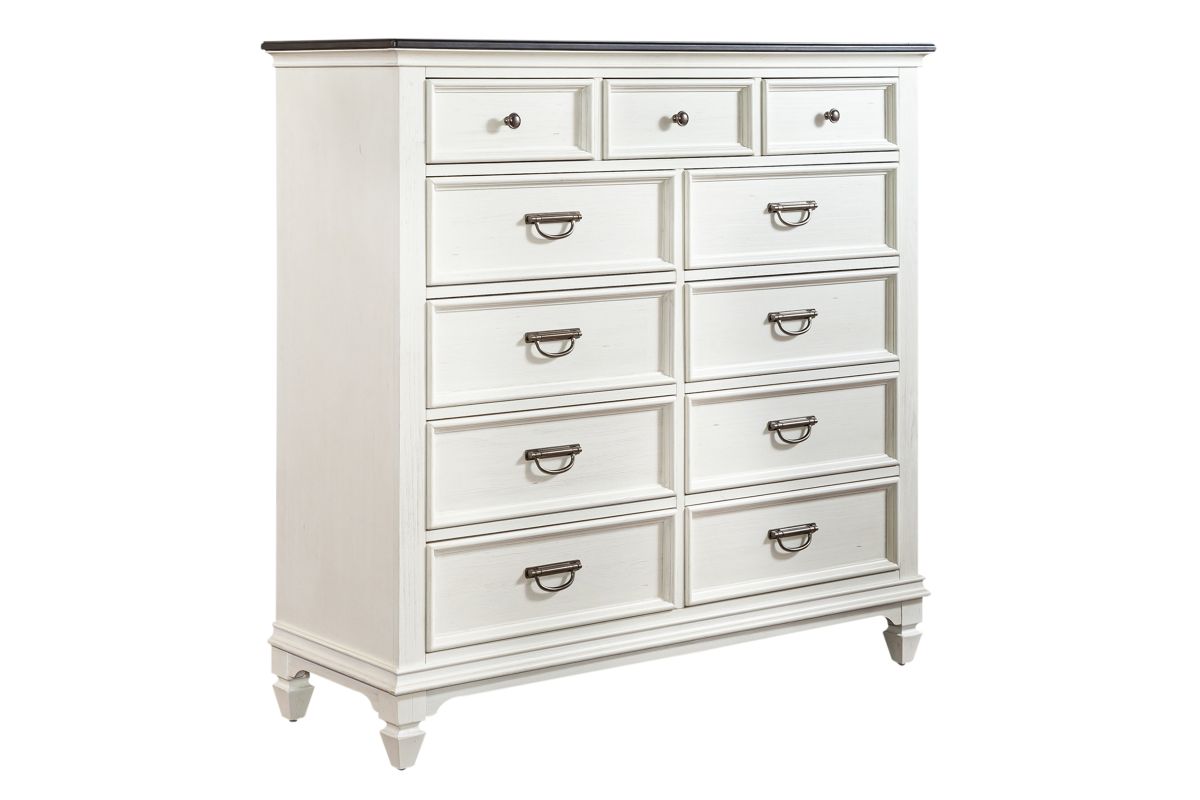 Corner view of a white wood chesser with 11 drawers.