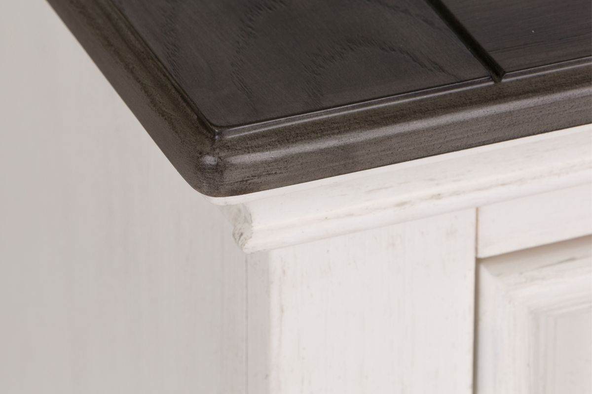 Close up image of the white and dark brown wood top corner of a Higgins Chest