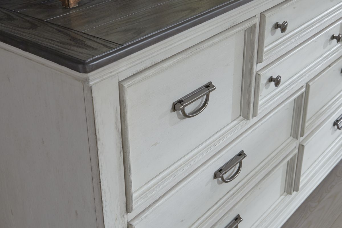 The front left corner of the Higgins Dresser showing white front and dark brown top