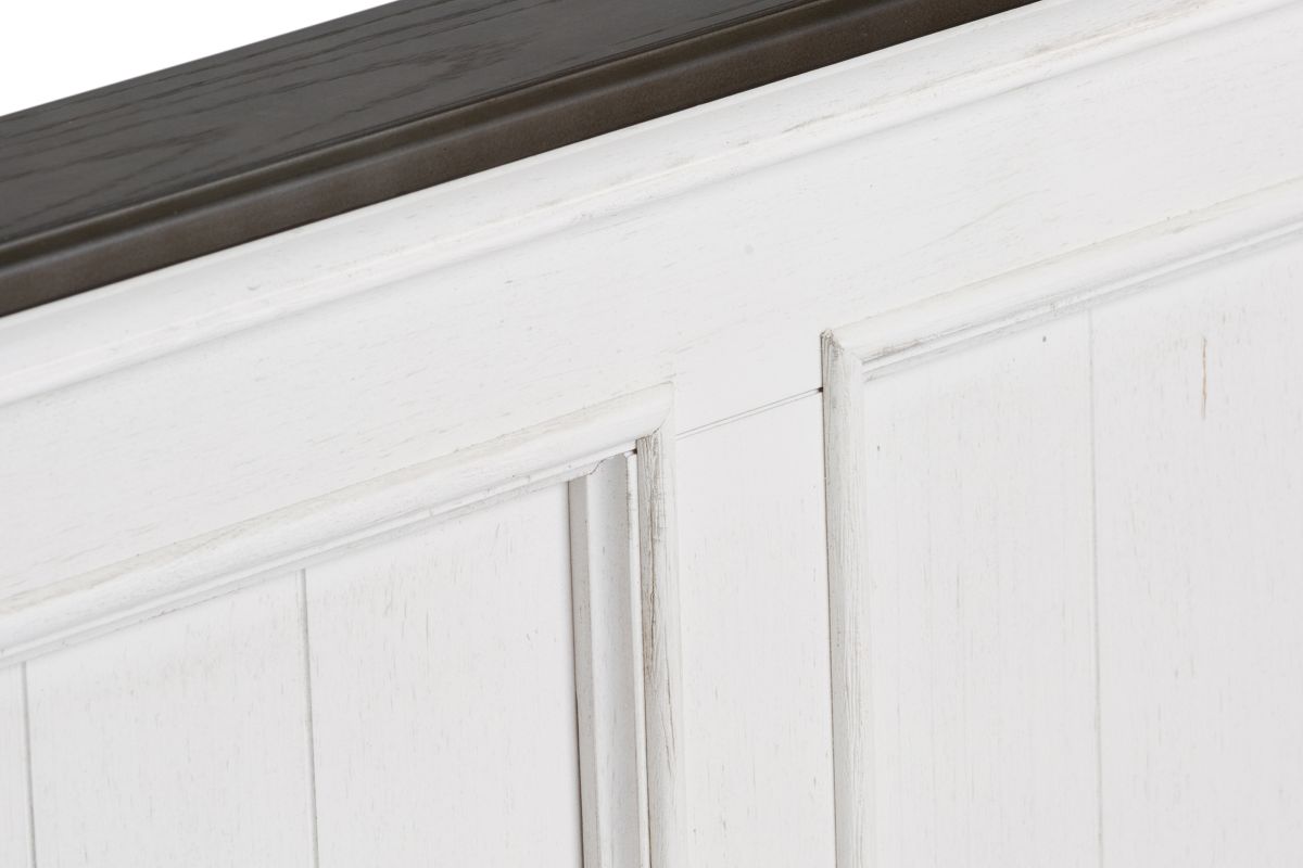 A close up image of the white and dark brown wood on a Higgins Bed